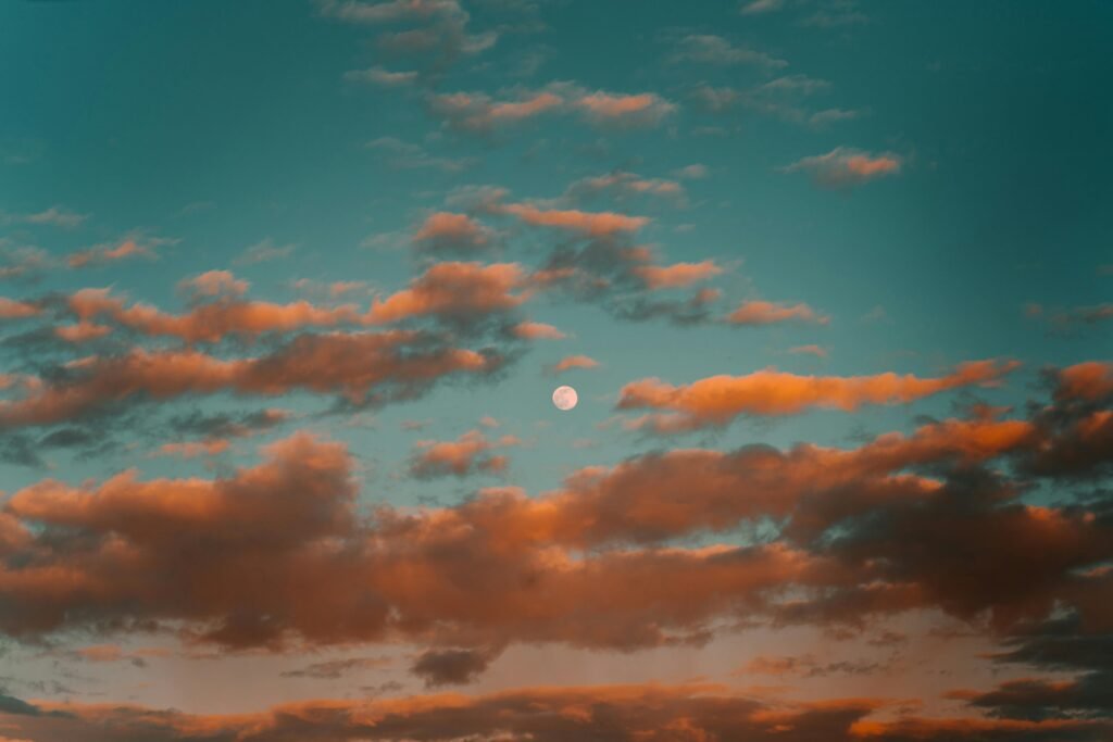 pexels-photo-7619883-7619883 Captivating twilight view of a full moon surrounded by colorful clouds.