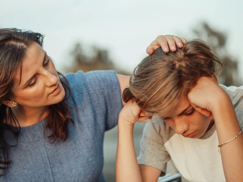 pexels-photo-8550841-8550841 A mother offers support to her discouraged teenager son, portraying love and understanding.